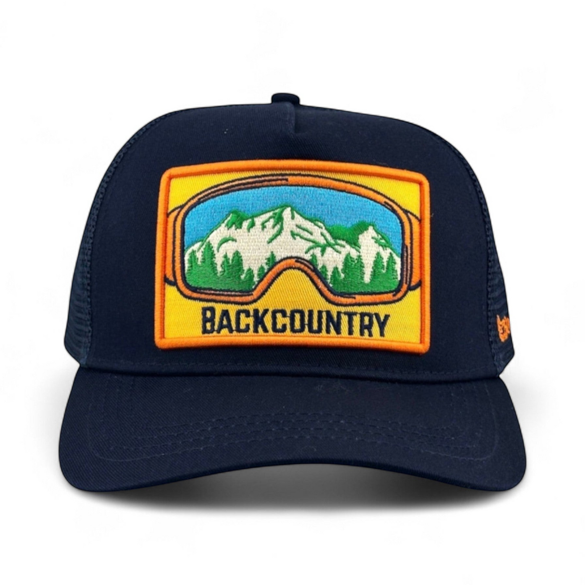 Soulbyrd Wholesale navy cotton trucker hat with a mountain and ski goggle patch featuring the word BACKCOUNTRY