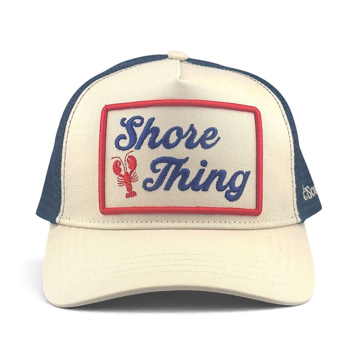 Soulbyrd Wholesale Shore Thing trucker hat in cream cotton twill and navy nylon mesh with a lobster graphic patch