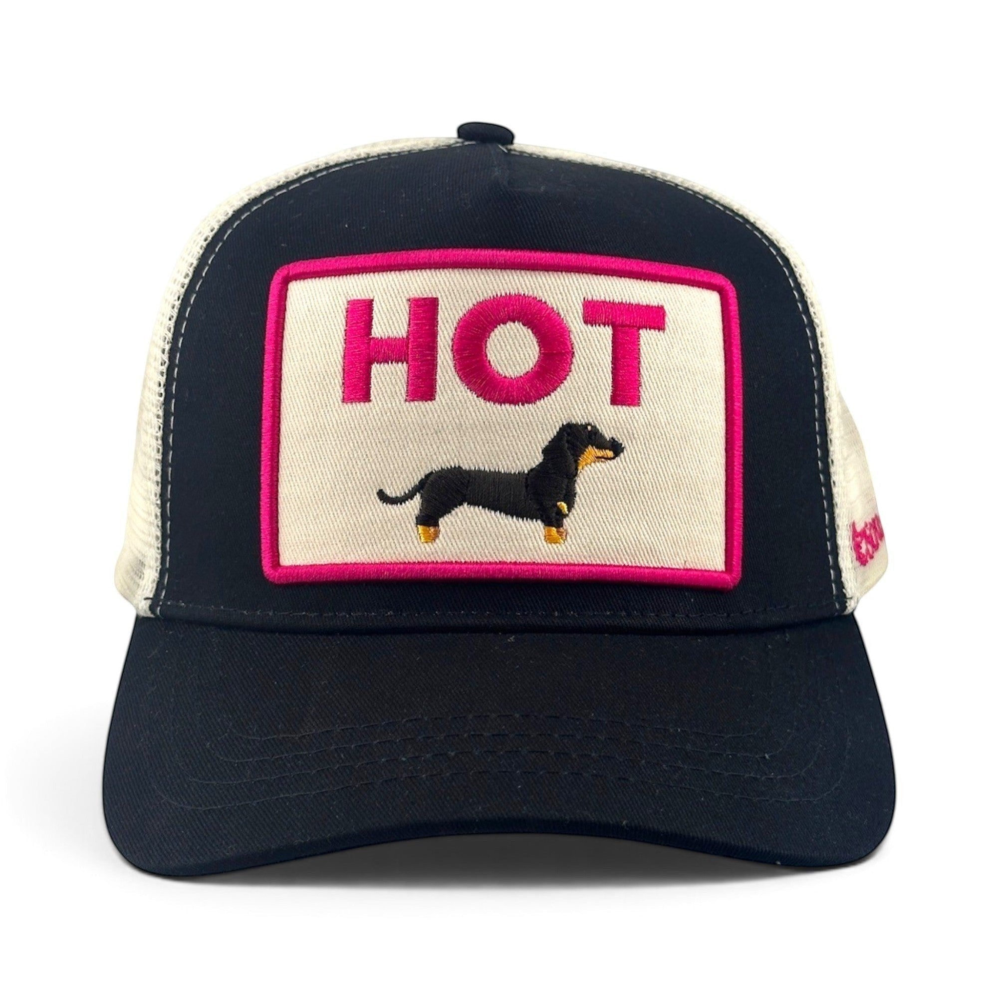 Soulbyrd Wholesale black cotton twill and mesh trucker hat with a pink Hot Dog patch featuring a dachshund graphic.