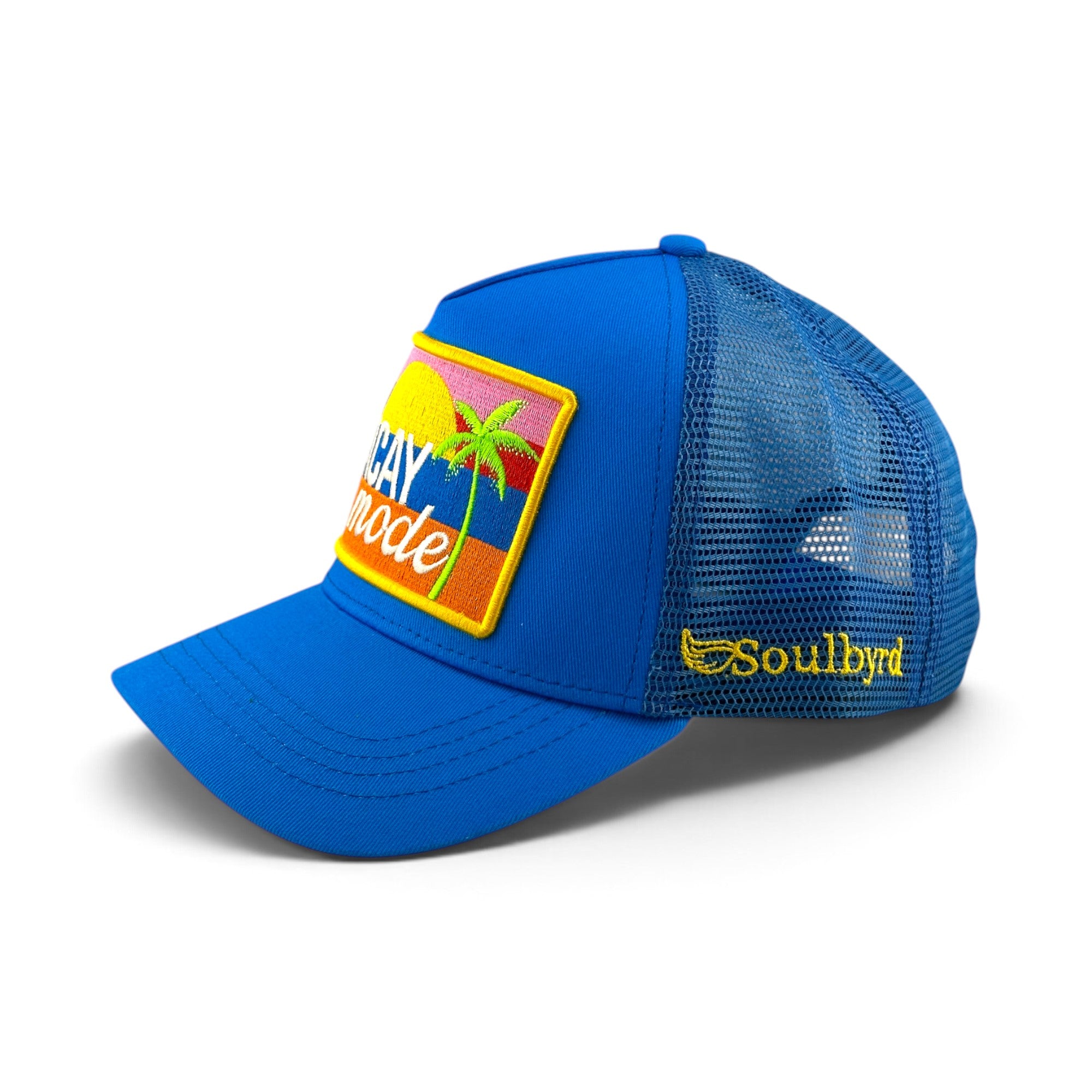 Soulbyrd Wholesale blue trucker hat with cotton twill front, nylon mesh back, and Vacay Mode palm tree patch.