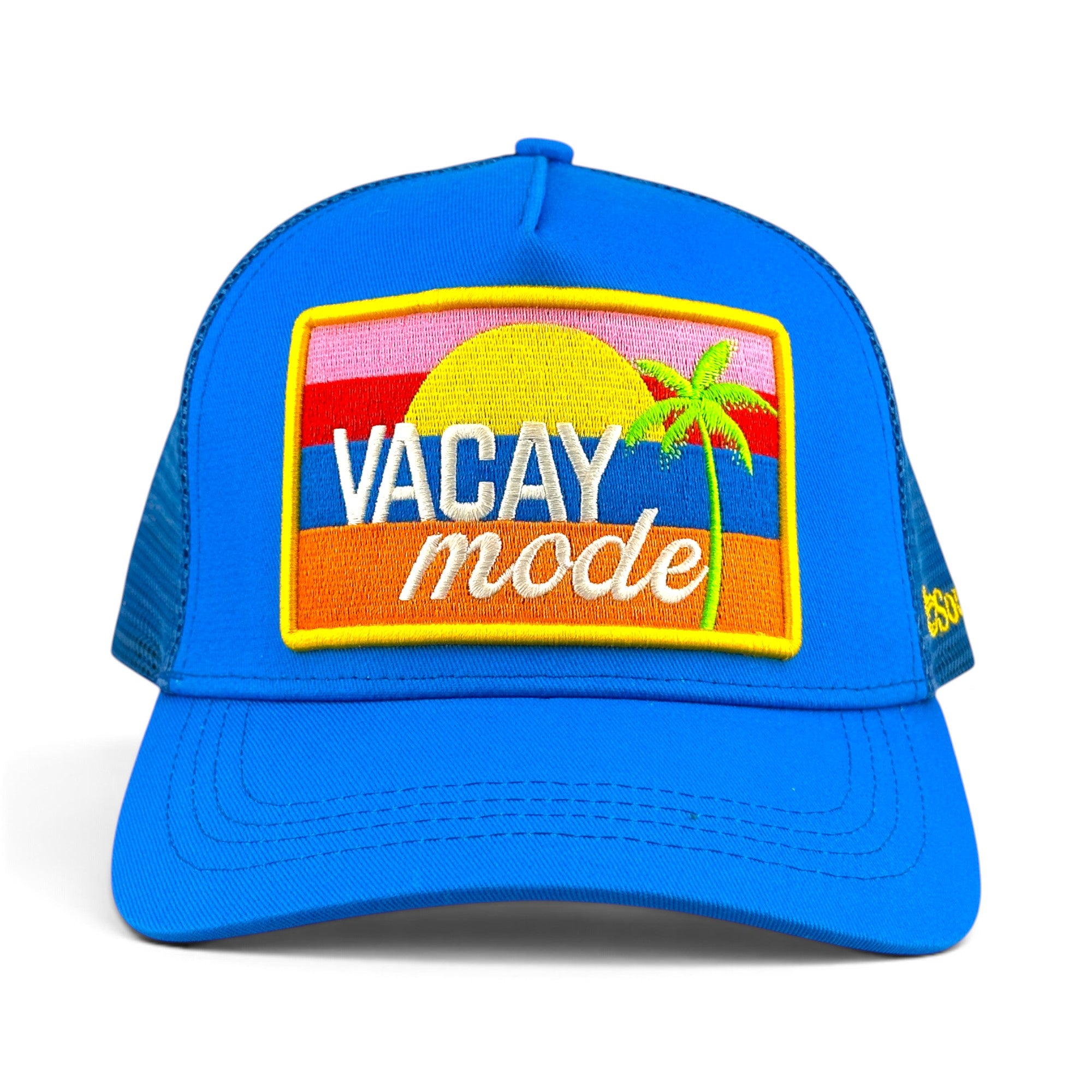 Soulbyrd Wholesale blue trucker hat with a Vacay Mode patch featuring a sunset and palm tree design.
