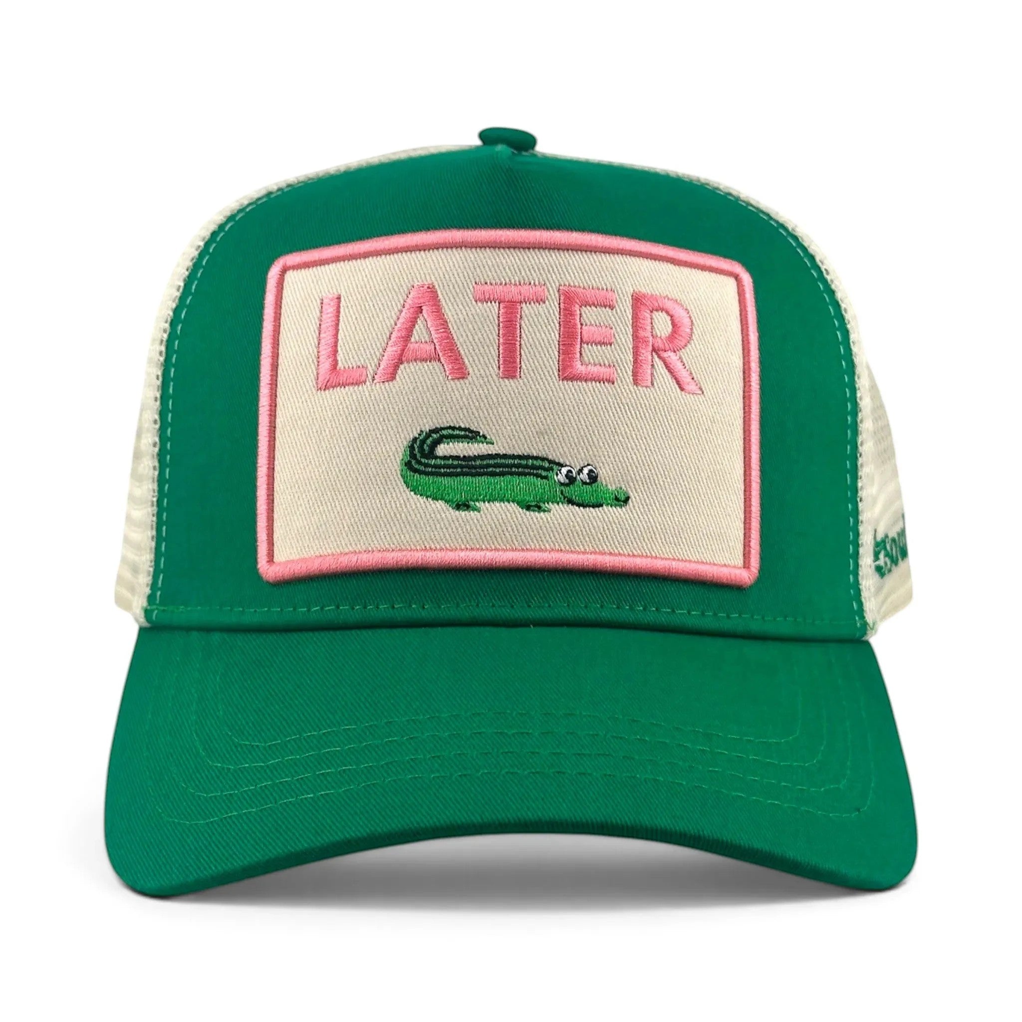 Soulbyrd Wholesale green trucker hat with a cream patch featuring pink LATER text and a cute alligator graphic.