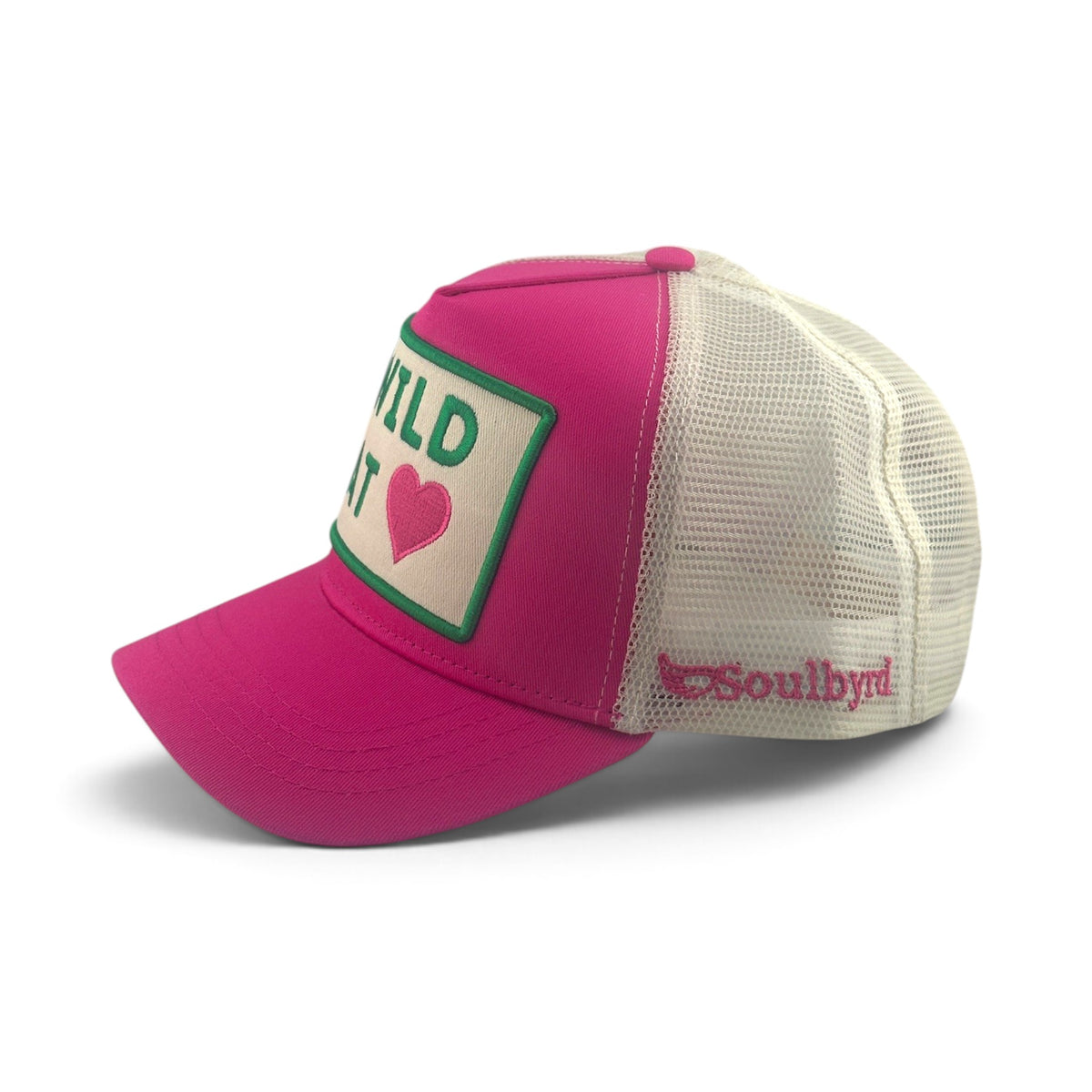 Soulbyrd Wholesale bright pink trucker hat with white mesh back, featuring a Wild at Heart patch and side logo.
