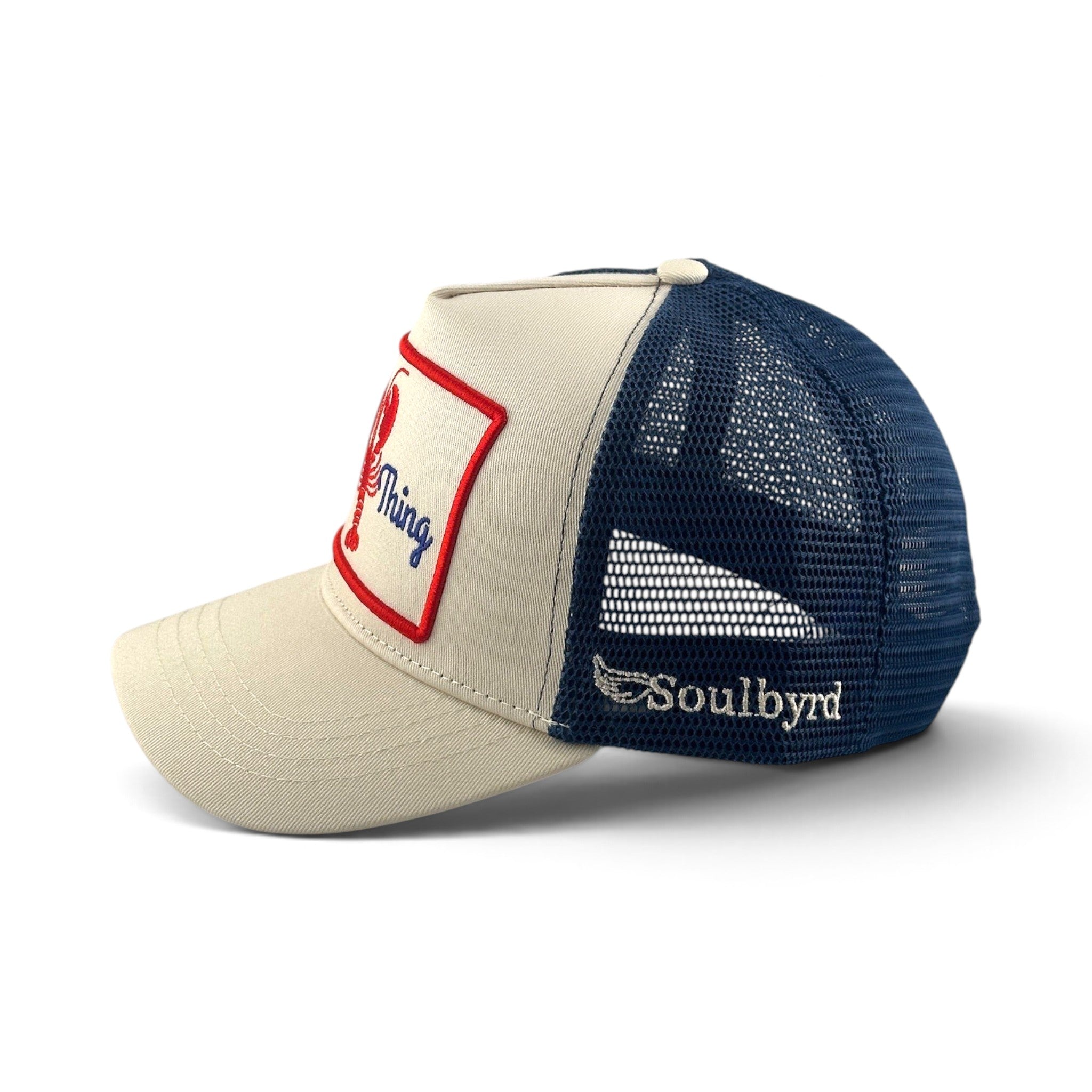 Soulbyrd Wholesale Shore Thing cream and navy trucker hat with cotton twill front, nylon mesh back, and snap closure.