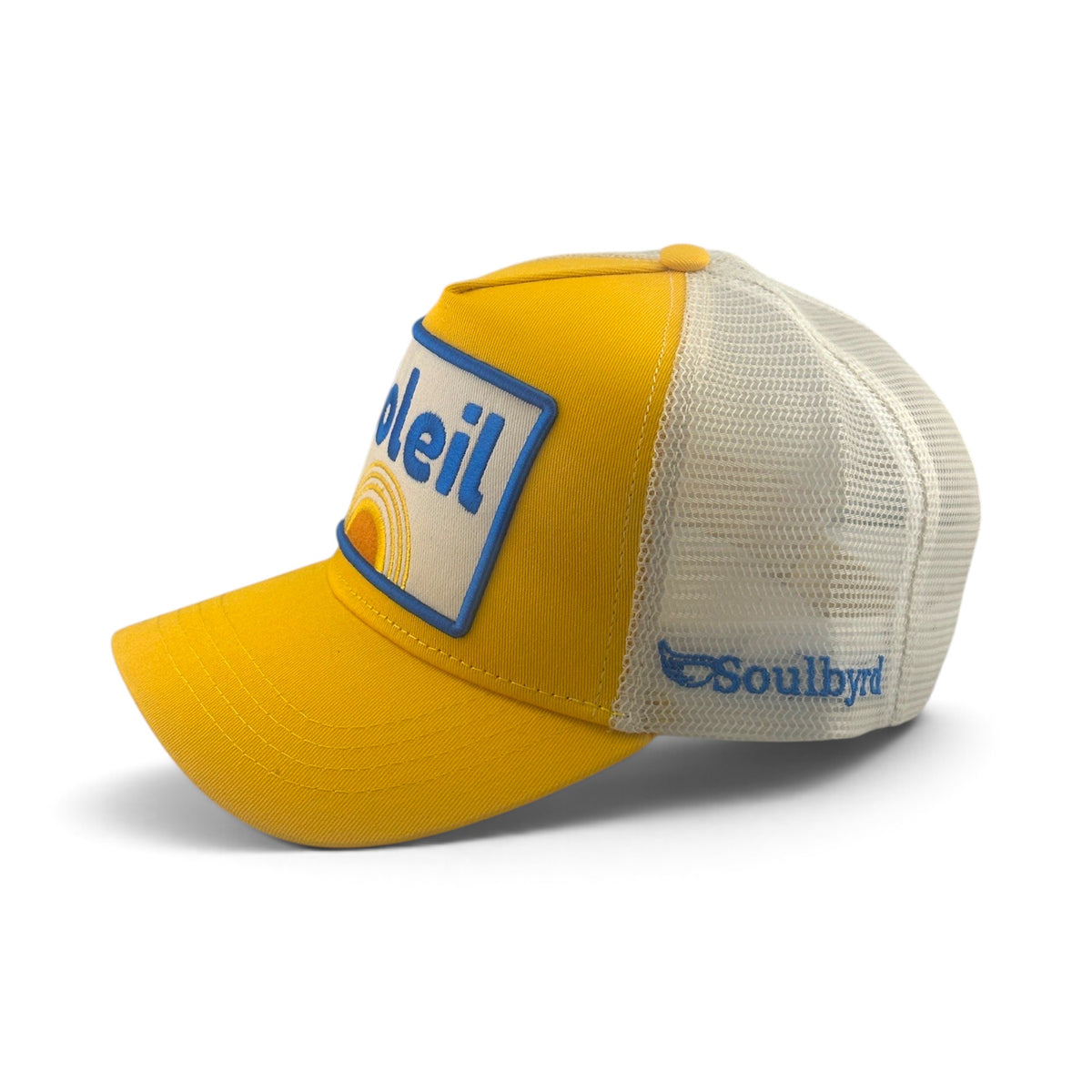 Soulbyrd Wholesale yellow Soleil trucker hat with cotton twill front, white nylon mesh back, and snapback closure.